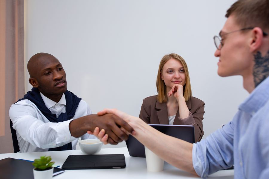 Business professionals shaking hands after a successful meeting