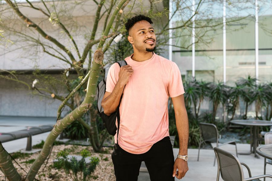 Young professional exploring a new city, backpack in hand