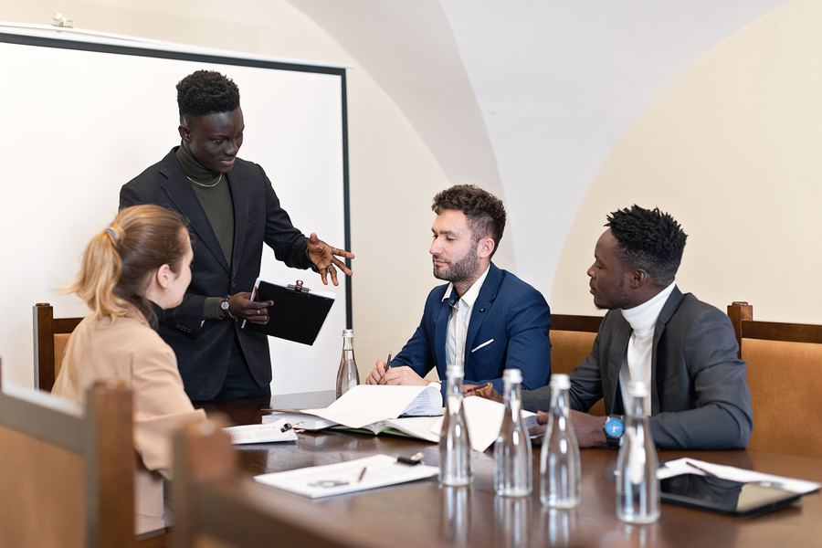 Rentsmiths-style consultancy team briefing clients around a table